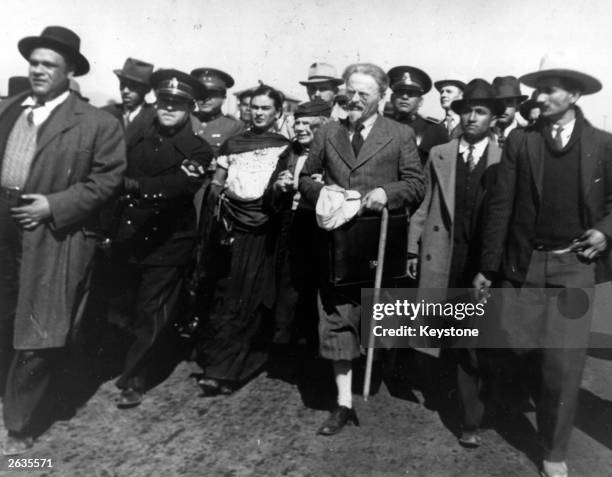 Leon Trotsky and his wife arrive in Tampico, Mexico, surrounded by plain clothes policemen, with his wife , and Mexican artists Frida Kahlo and Diego...