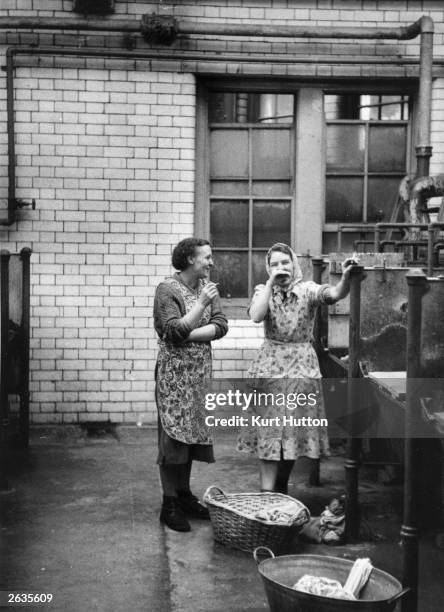 Women chatting in a public wash house in Newcastle. Original Publication: Picture Post - 7801 - Newcastle Wash House - unpub.