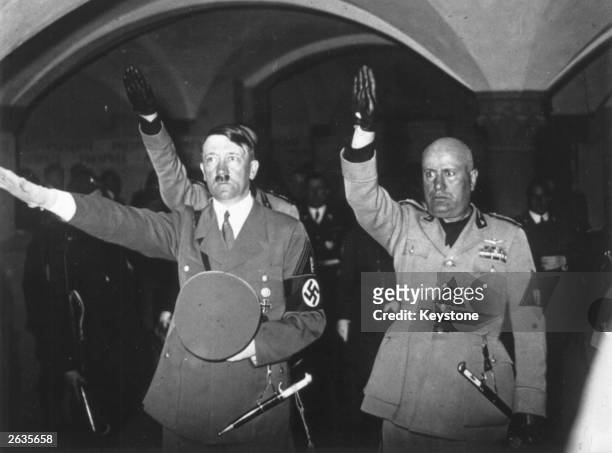 Hitler and Mussolini giving the Fascist salute at the Tomb of the Fascist Martyrs in Florence.