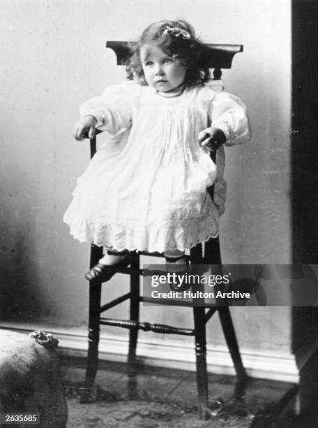 Lady Elizabeth Bowes-Lyon , future Queen Consort to King George VI sitting in a high chair on her second birthday.