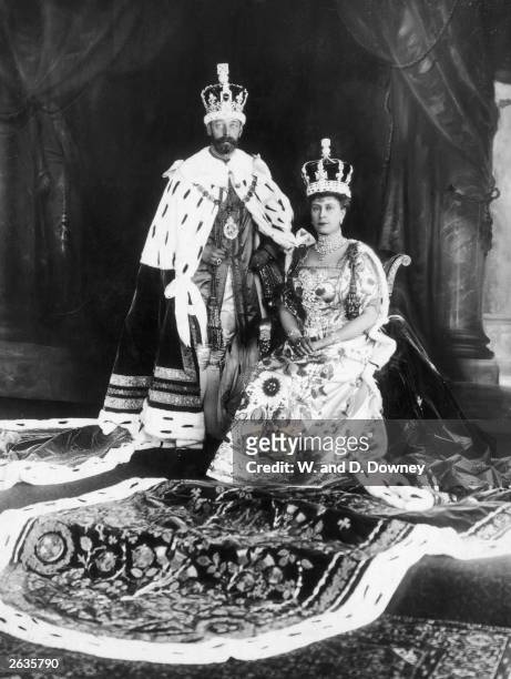 George V , King of Great Britain, on the day of his coronation, together with his consort Queen Mary in full ceremonial costume and wearing crowns.
