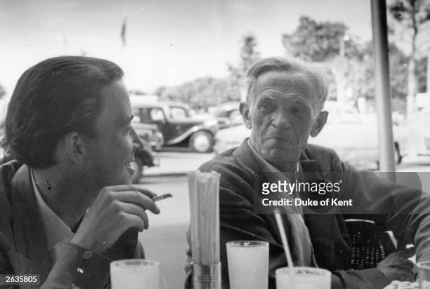 'Picture Post' photographer Kurt Hutton , in a cafe during a business trip to Geneva, with the retained ?fixer/researcher? Alex Koziell. The picture...