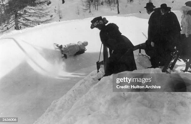 Spectators watching an English woman on the Cresta Run, Saint Moritz, Switzerland.