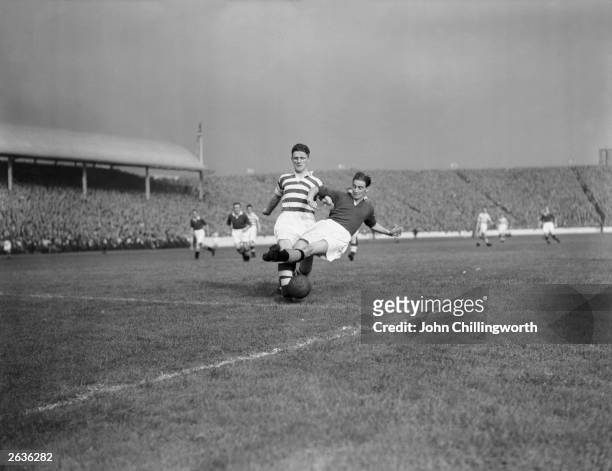 Footballers Evans of Celtic and Cox of Glasgow Rangers compete for the ball during a derby match at Ibrox Stadium, Glasgow. Large crowds gather for...