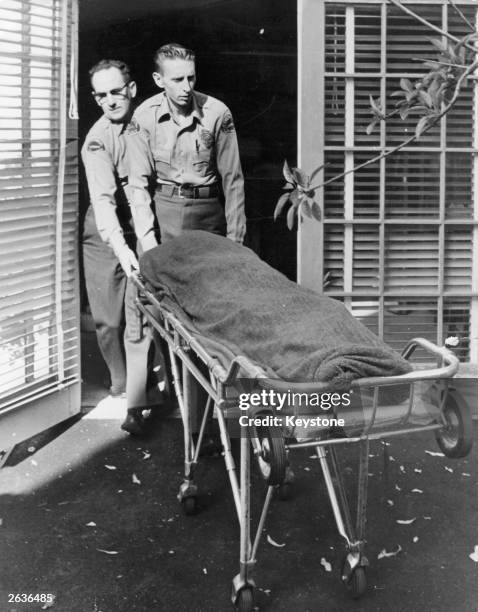 Medical attendents removing the body of Marilyn Monroe from her home.