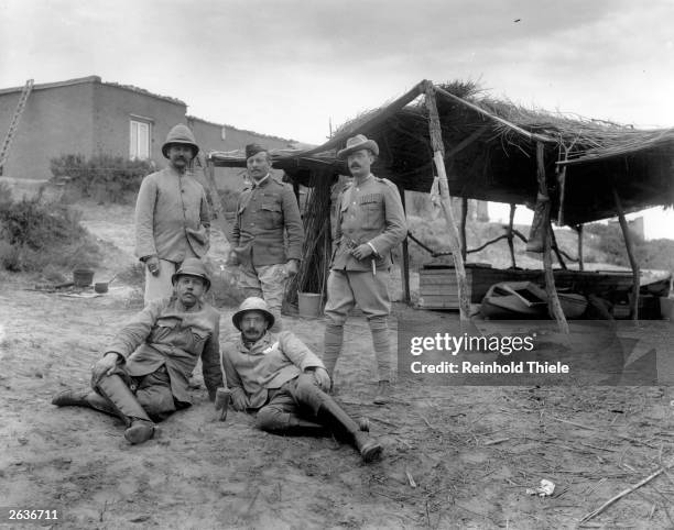 Group of war correspondants on Glovers Island during the Boer War, circa 1900. On the ground are US journalist Julian Ralph and Howell Arthur Gwynne...