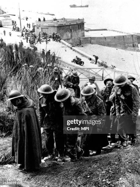 Weary British soldiers waiting for evacuation from Dunkirk.