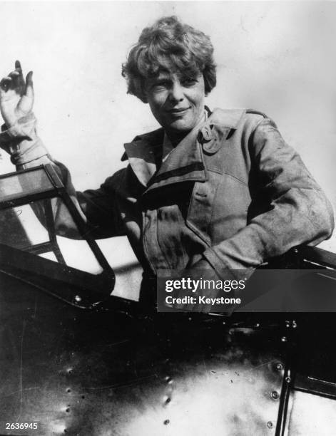 Amelia Earhart an American pilot, the first woman to fly the Atlantic, seen here in the cockpit of her plane.