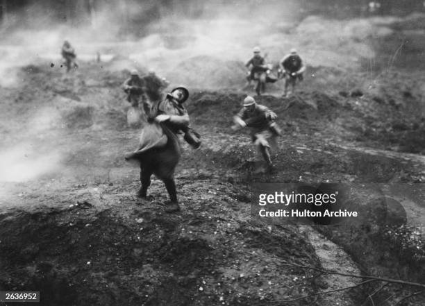 French soldiers on the battlefield, during an offensive action on the French fortress town of Verdun. A still from the 1928 film 'Verdun, Visions...