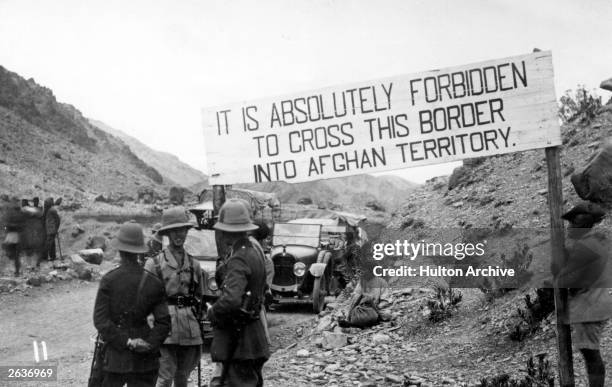 An Afghan border crossing at the Khyber Pass manned by British troops during the Third Anglo-Afghan War, it is marked by a sign which reads 'it is...