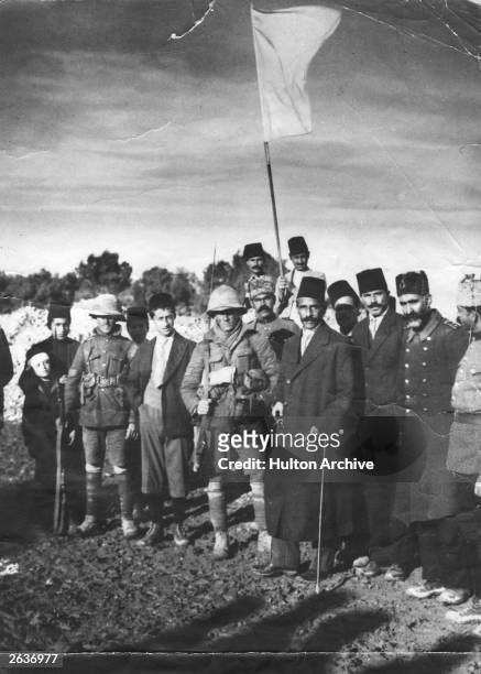 The Mayor of Jerusalem, Hussein Husseini, 3rd from right, surrenders the Holy City to Sergeant F H Hurcomb, 5th from right. Also present Sergeant...