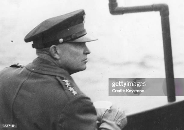 General Dwight D Eisenhower , Supreme Commander of the Allied Forces, watches the Allied landing operations from the deck of a warship in the English...