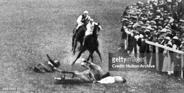 English Suffragette Emily Davison throws herself under King George V's horse, 'Anmer', at the Epsom Race Course.