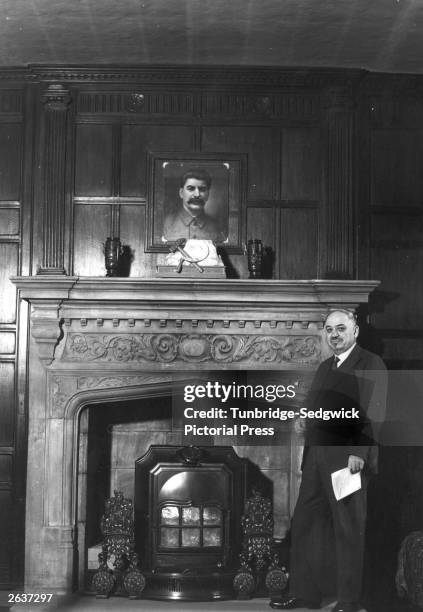 Russian Ambassador to the United Kingdom, Ivan Michaelovich Maisky at the Russian Embassy standing below a picture of Stalin, July 1940.