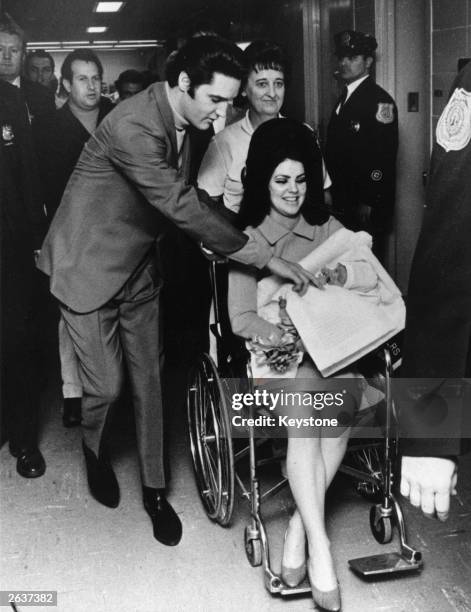 Singer Elvis Presley and his 22 year-old wife Priscilla, leaving the Baptist Hospital, Memphis, Tennessee, with their baby daughter Lisa-Marie, born...