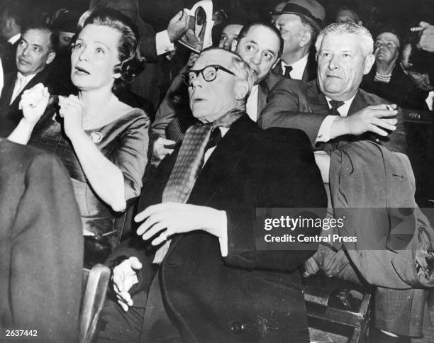 The Duke of Windsor , who reigned in 1936 as Edward VIII, sits next to the singer Jane Pickens Langley at a boxing match as Floyd Patterson delivers...