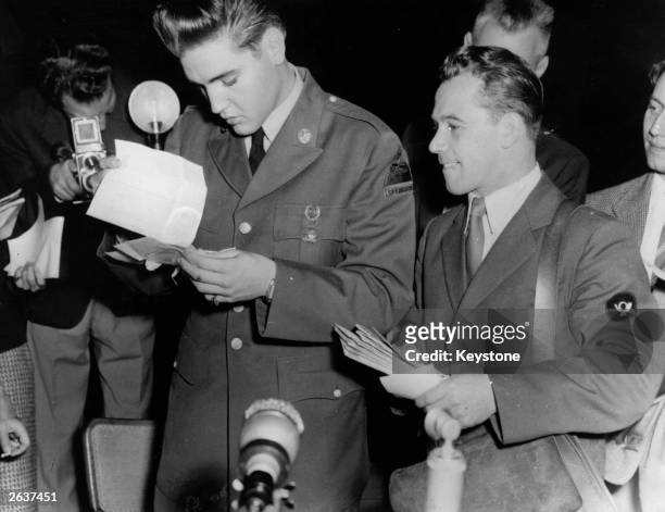 Rock 'n' roll star Elvis Presley , now a GI, receives his first bundle of mail at the Friedberg US Army base in Germany, where he will serve sixteen...