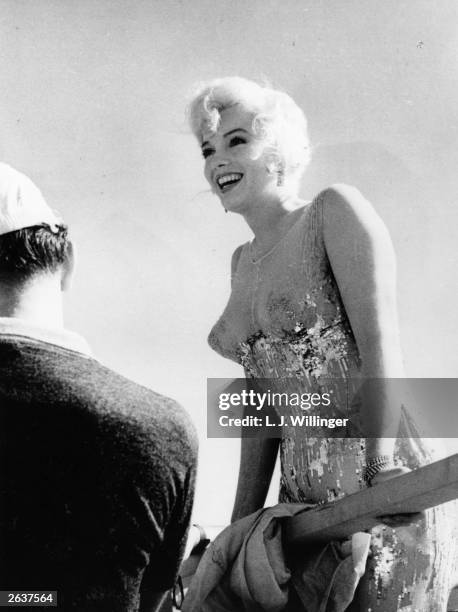 American film actress Marilyn Monroe in between shots on the set of 'Some Like It Hot', directed by Billy Wilder. Costume by Orry-Kelly. Original...