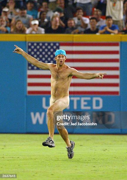 An unidentified streaker runs across the outfield following the end of the seventh inning during game five of the Major League Baseball World Series...