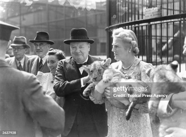 British wartime prime minister Winston Churchill with his wife Clementine holding a lion cub during a trip to London Zoo.
