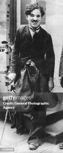 English film actor and director Charlie Chaplin between takes during the filming of the 1917 silent film 'Easy Street'. Original Publication: People...