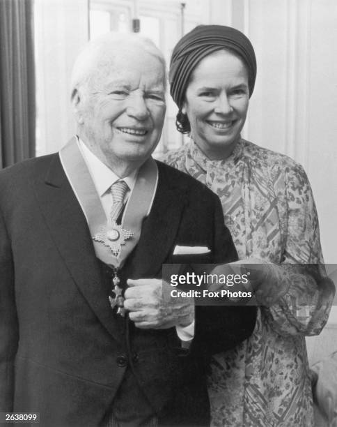 Charlie Chaplin , English film actor and director, with his wife Oona O'Neill after receiving a Knighthood from Queen Elizabeth II at Buckingham...