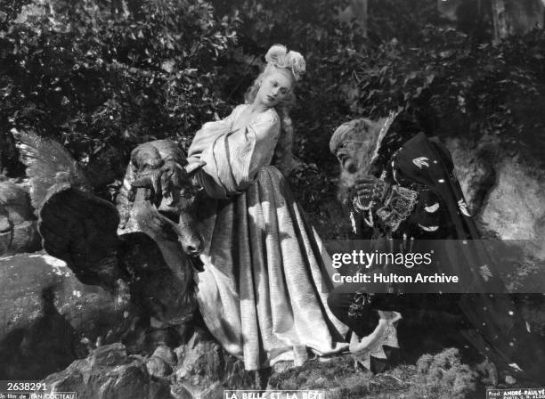 Jean Marais kneels at the feet of Josette Day in a scene from Jean Cocteau's beautifully surreal film 'La Belle Et La Bete', based on the children's...