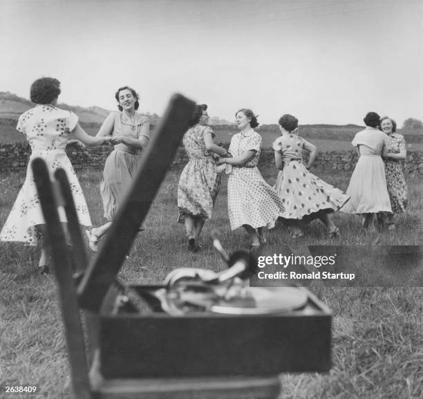 Members of Eastgate Women's Institute practising country dancing to a gramophone in the fields of Weardale, County Durham. Original Publication:...