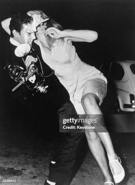 Yugoslav actress Sonia Romanoff attacks paparazzo photographer Rino Barillari with an ice cream, after he took an unflattering photograph of her on...