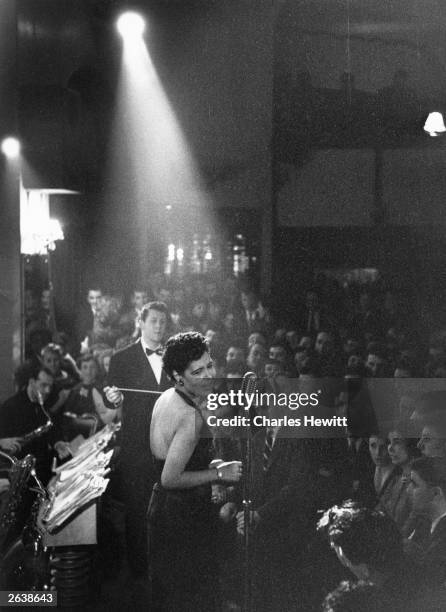 American jazz singer Billie Holiday in the spotlight during a performance. Original Publication: Picture Post - 7380 - Billie Holiday - unpub.