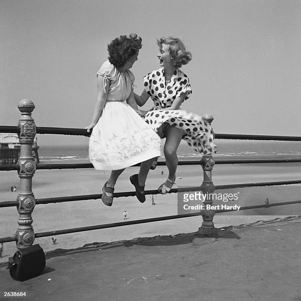 Two women chatting on the railings in Blackpool, July 1951. The picture was taken by Bert Hardy using a single-focus box camera. The women are former...