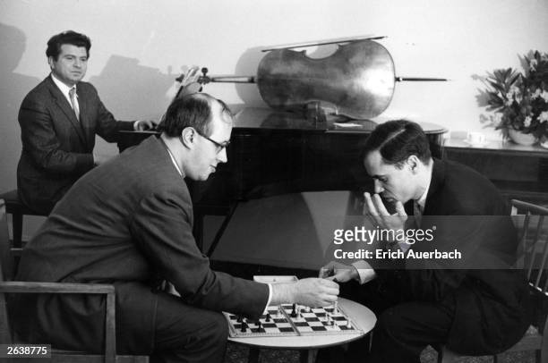 The Russian pianist Emil Gilels, , is at the piano, while Leonid Kogan and the Russian cellist and conductor Mstislav Rostropovich play chess in...