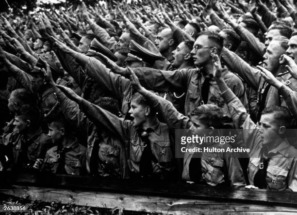 Some of the 48,000 boys and 5,000 girls who attended the Nazi Party Congress rally in Nuremberg cheering and saluting Adolf Hitler's speech.
