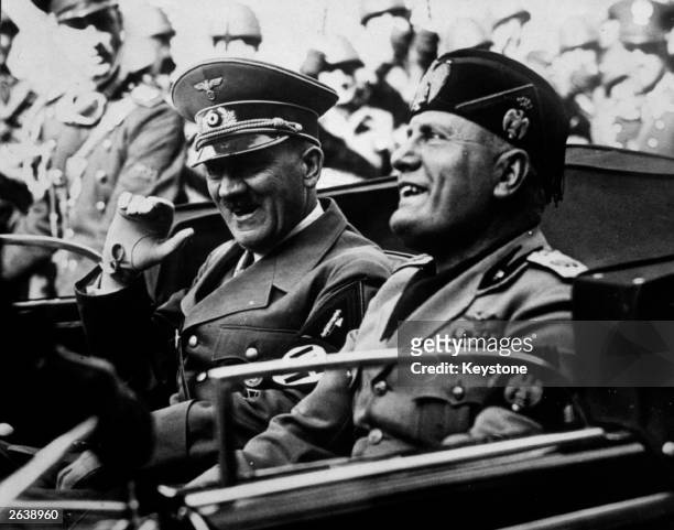 German dictator Adolf Hitler and his Italian counterpart Benito Mussolini share a joke during a drive in Florence.