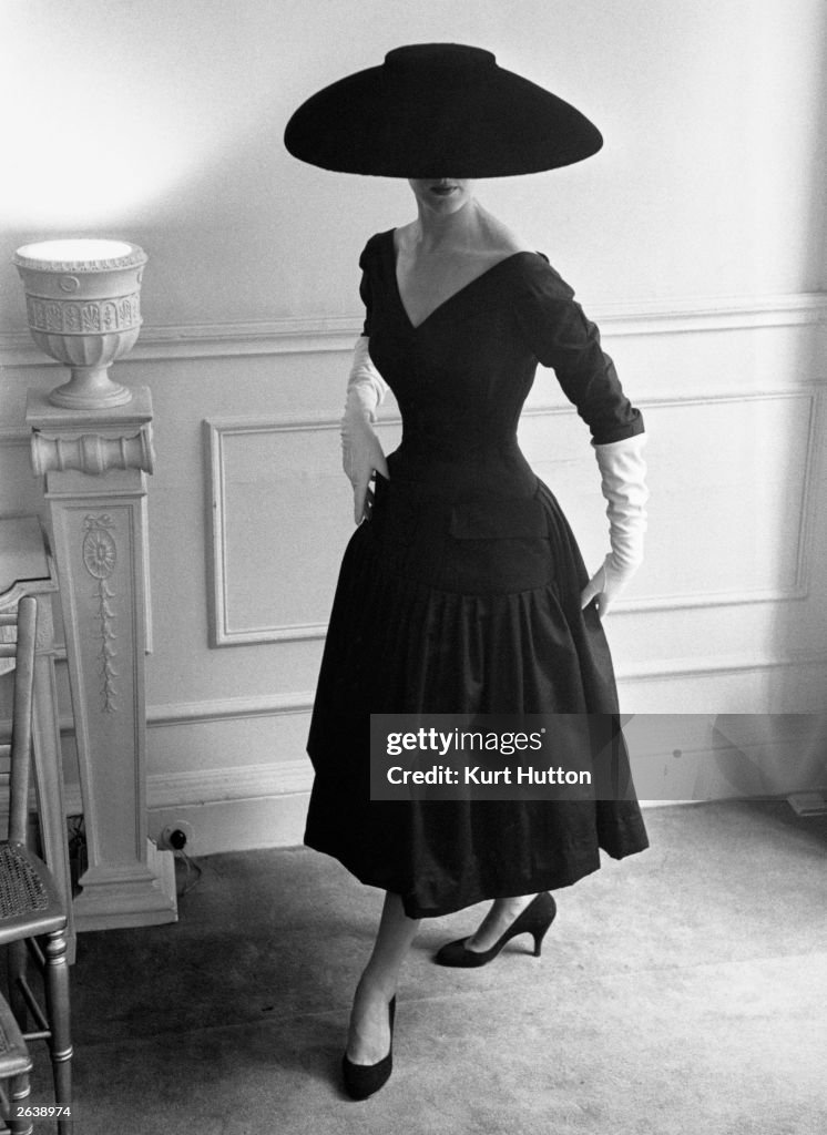A model wearing a black cocktail dress and a black velvet... News Photo ...