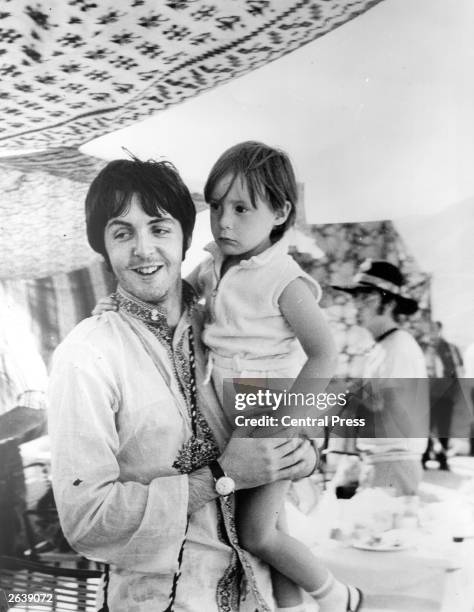 Beatles singer and bass player Paul McCartney holds four year old Julian, son of his colleague John Lennon during a holiday near Athens in Greece.