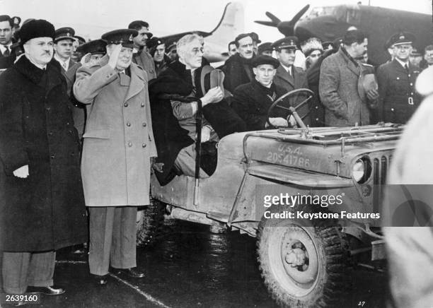 American President Franklin Delano Roosevelt in a jeep after arriving at Yalta airport for the Big Three Conference, also in the photograph are...