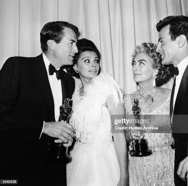 Actors Gregory Peck , Sophia Loren, Joan Crawford and Maximilian Schell stand backstage at the Academy Awards, Santa Monica Civic Auditorium, Los...