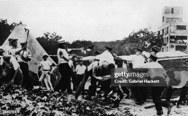 Police forcibly remove World War I Bonus March demonstrators from their shanty campsites in Washington, D.C., July 1932. The Bonus Marchers were...