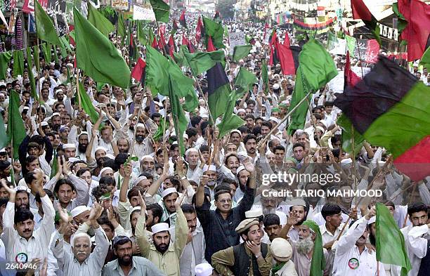 Activists and supporters of Pakistan's main opposition party, Alliance for Restoration of Democracy , display party flags during a rally in the...