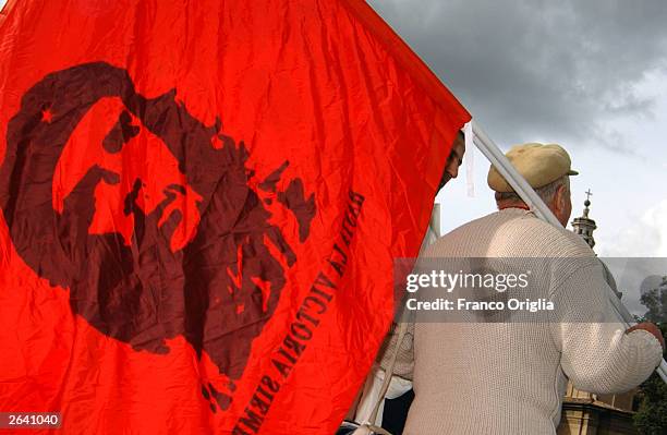 Man walks with a Che Guevara flag during a demonsration against pension reforms planned by the government of Italian President Silvio Berlusconi...