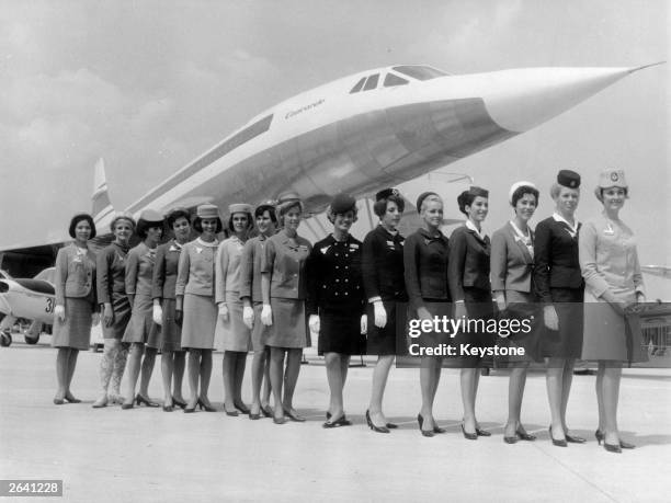 Line-up of some of the air stewardesses who attend to passengers on board the supersonic jet the 'Concorde', each one from a different airline. They...