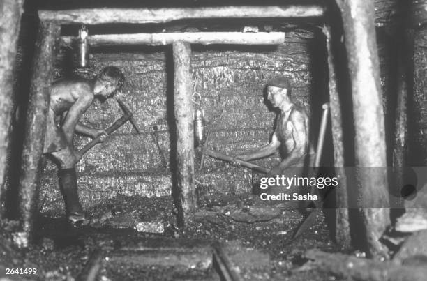 Miners working at the coal face of Tilmanstone colliery, Kent. The photograph was taken using a 'Sashalite', one of the first safe photographic flash...