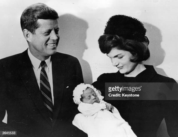John F Kennedy , American president-elect, with his wife Jacqueline at the christening of their son John F Jr. In Washington.