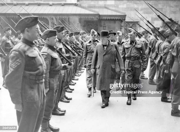 British statesman Sir Winston Leonard Spencer Churchill, , who held office as Prime Minister from May 1940 to July 1945, inspects the Home Guard. He...