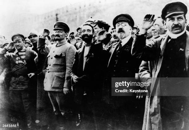 Communist leaders including Joseph Stalin and Leon Trotsky seen saluting in the street during the Russian Revolution.