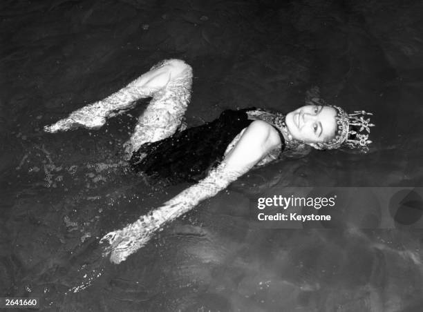 Esther Williams, American aquatic actress rehearsing in the water at Wembley Pool for her forthcoming aqua show.