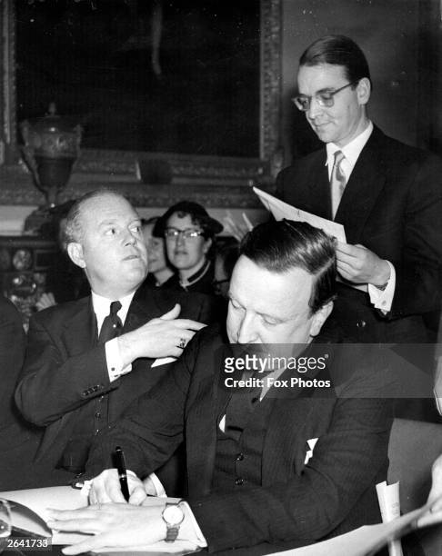 Hermann Josef Abs in Londonderry House, London, signing a West German government agreement to repay 300 million marks annually to 27 nations to clear...