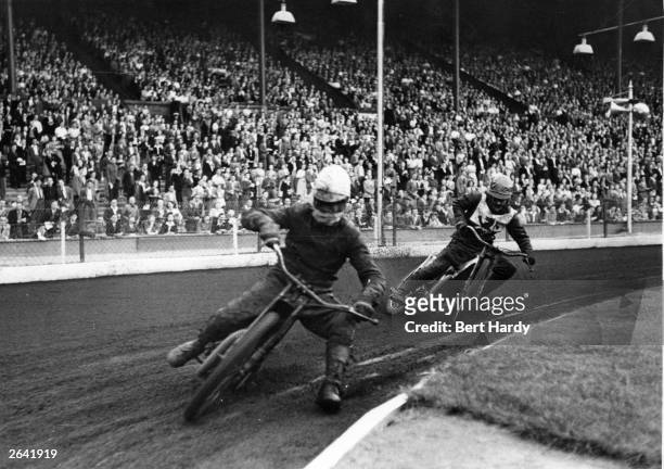Eighteen-year-old speedway rider Buster Brown taking a corner at speed during a race track meeting at Wembley. Original Publication: Picture Post -...