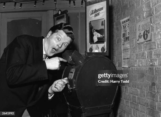 Benny Hill, British television comedian, looking in to see 'What The Butler Saw' during rehearsals of his new television show at the TV Theatre,...